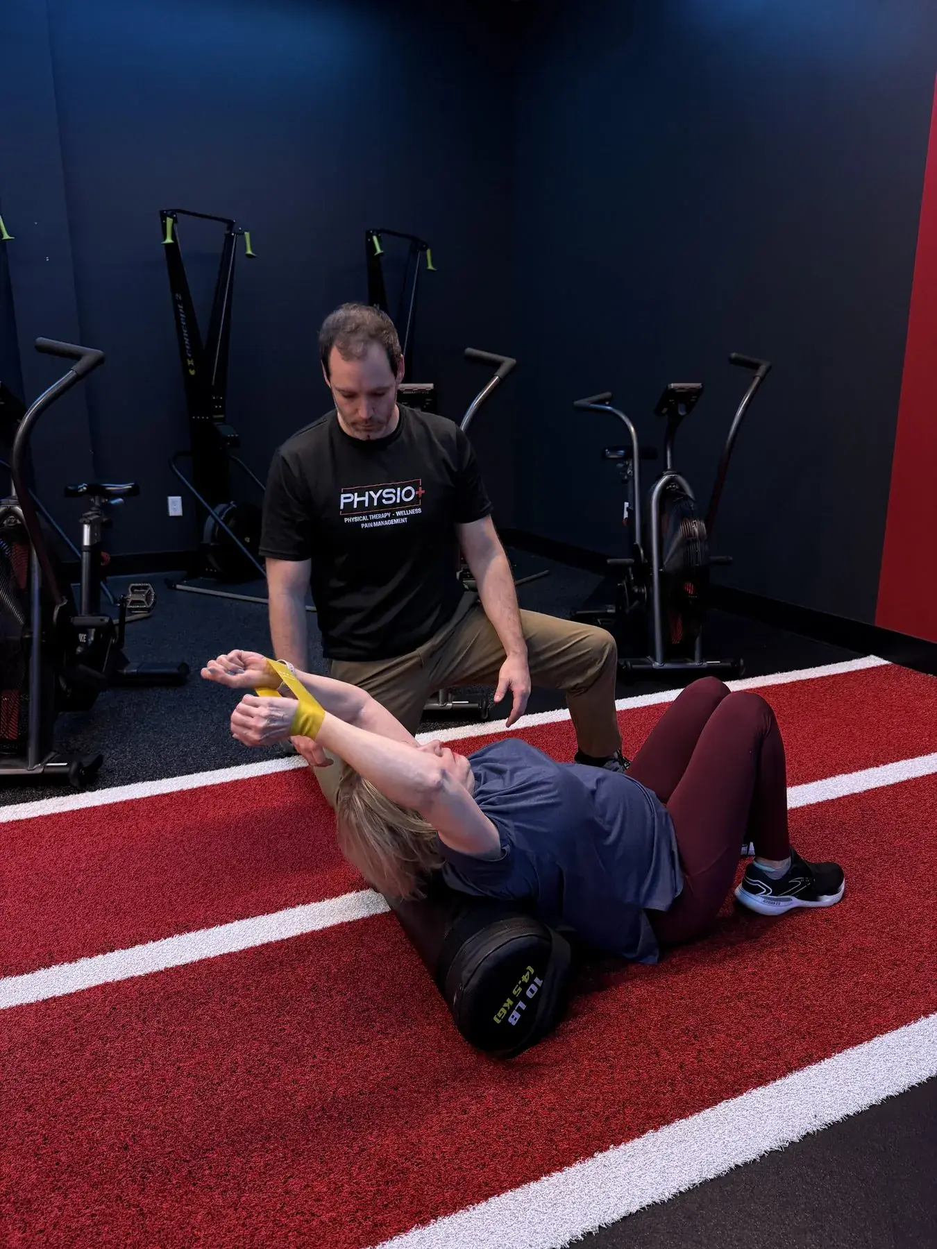 Ankle taping on the indoor track at Physio+