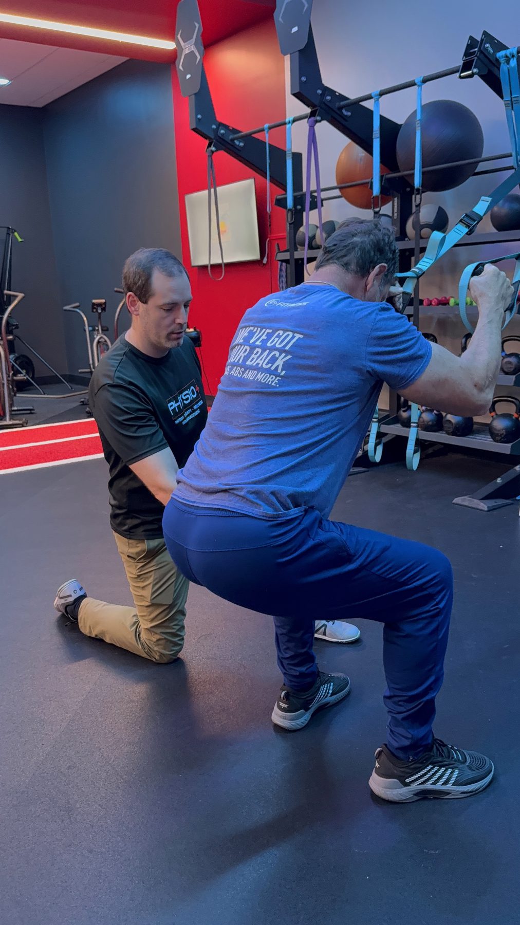 Loaded squat coaching at Physio+