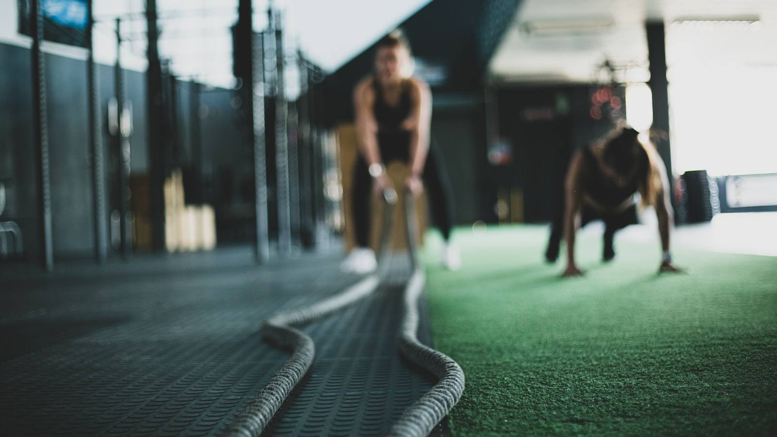Patient training under load during physical therapy at Physio+ inside an East Texas gym